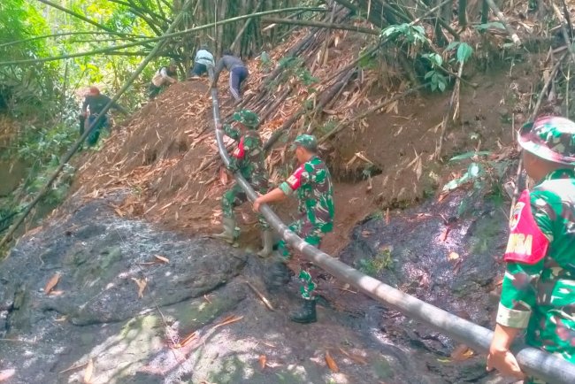 Babinsa Bendungan Bantu Pemasangan Pipa Saluran Air untuk Pengairan Sawah